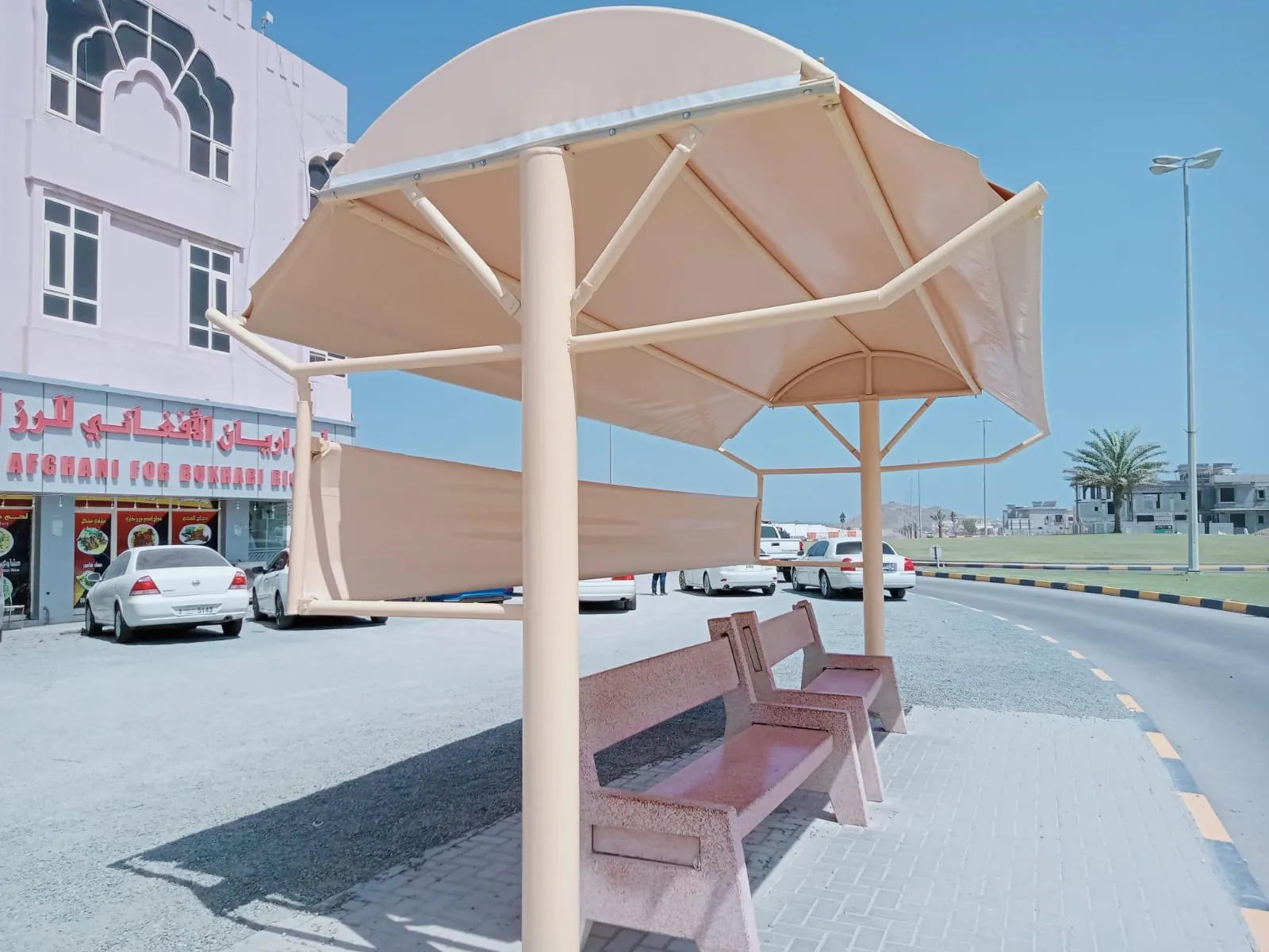 Finished bus shelter shade with PVC fabric and stone benches