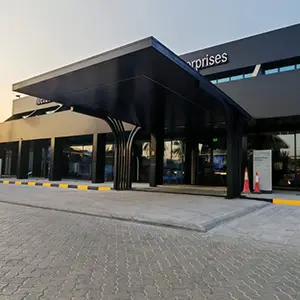 Powder-coated aluminium pergola over a commercial entrance in the UAE
