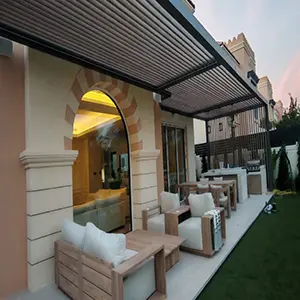 Motorised louvered pergola installed over a villa terrace with lounge seating